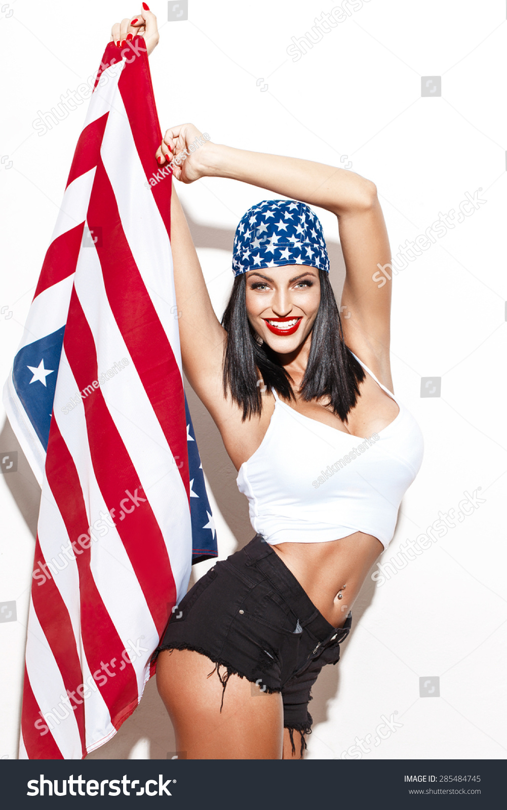 stock-photo-sexy-woman-holding-usa-flag-in-headscarf-at-white-wall-fourth-of-july-independence-day-285484745.jpg