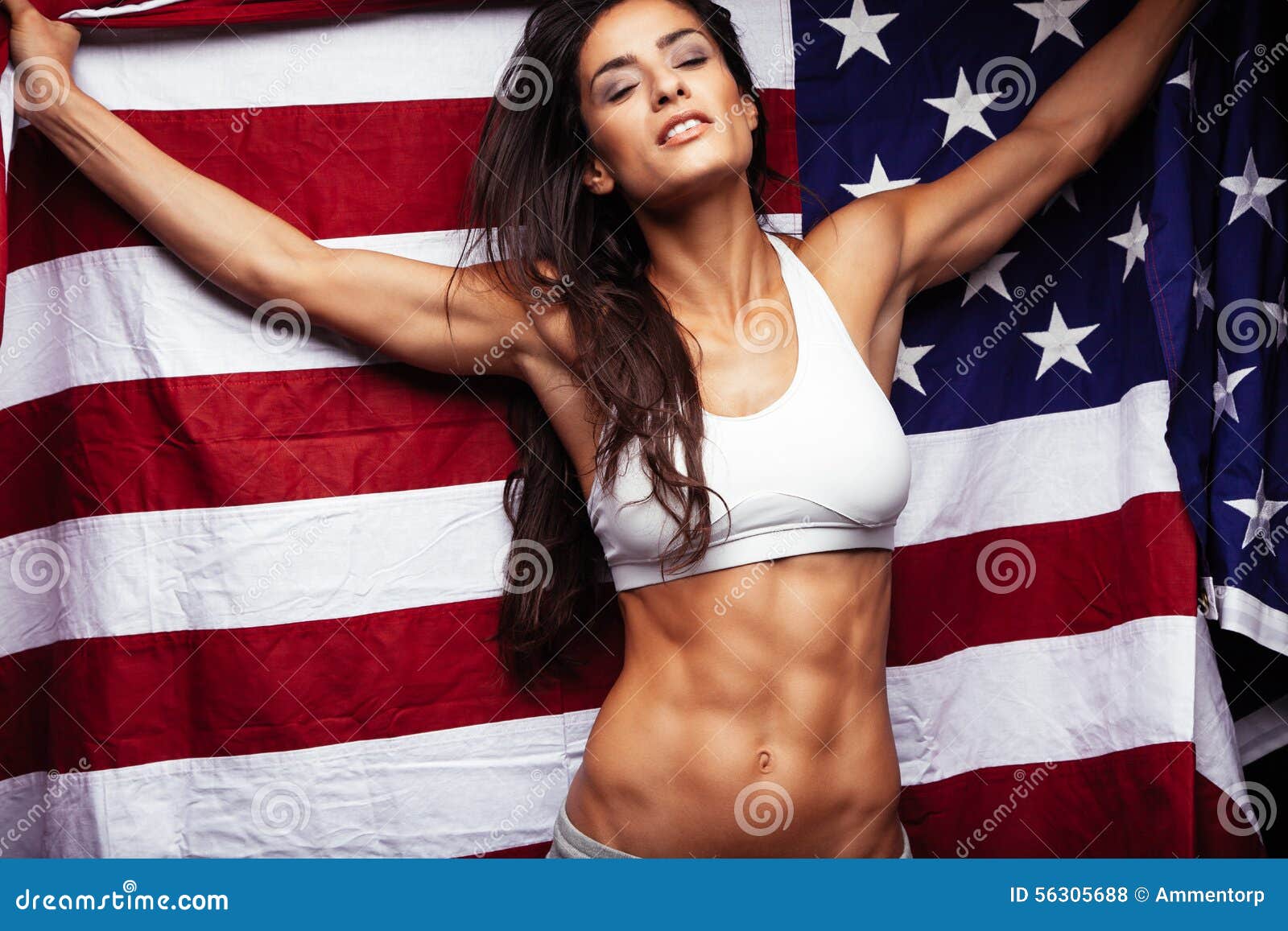 sporty-young-woman-holding-american-flag-fitness-female-perfect-abs-56305688.jpg